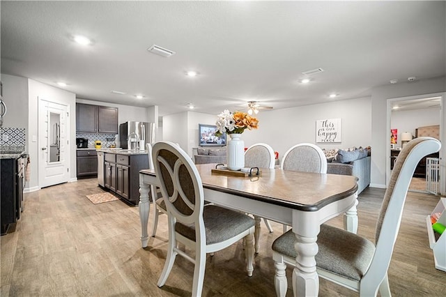 dining space featuring ceiling fan and light hardwood / wood-style flooring