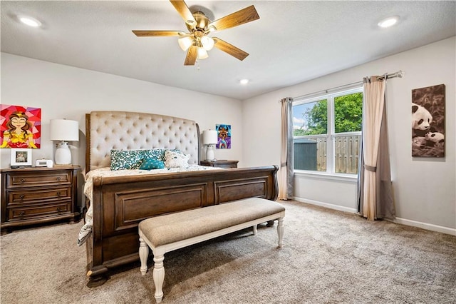 bedroom featuring ceiling fan and carpet