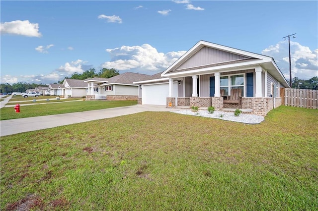 view of front of house featuring a front lawn, a porch, and a garage