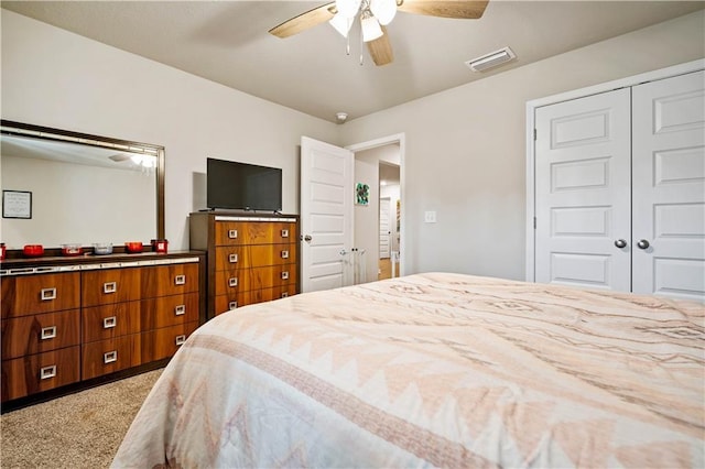 carpeted bedroom with a closet and ceiling fan