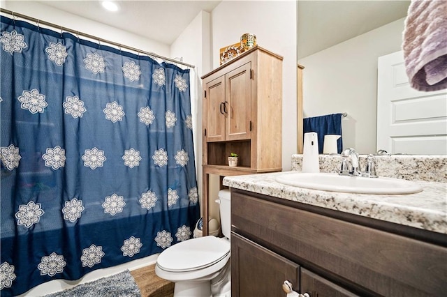 bathroom with toilet, a shower with curtain, hardwood / wood-style floors, and vanity