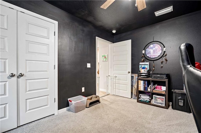 miscellaneous room with ceiling fan and carpet flooring