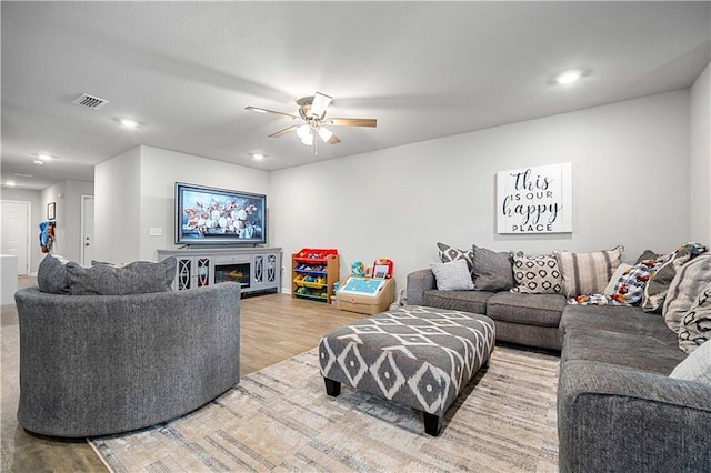 living room featuring ceiling fan and wood-type flooring