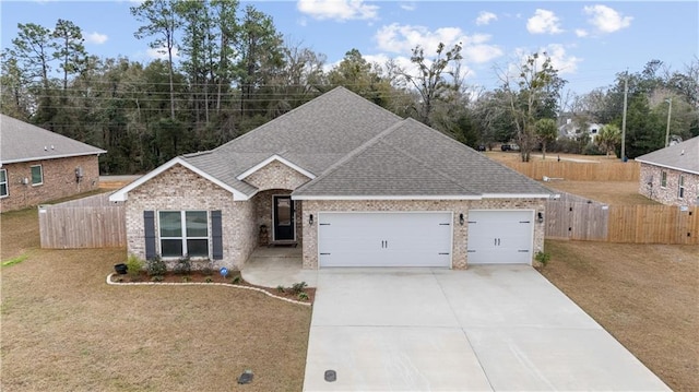 view of front of home with a garage and a front yard