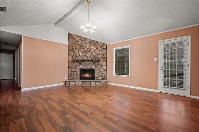 2301 Cedar Ky, Mobile, AL 36695 - unfurnished living room featuring wood finished floors, a chandelier, a textured ceiling, a stone fireplace, and wood walls
