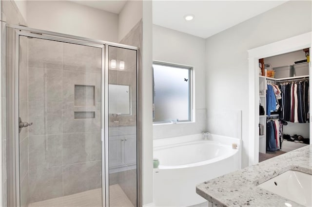 bathroom featuring vanity and separate shower and tub