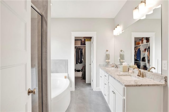 bathroom featuring independent shower and bath, vanity, and tile patterned floors