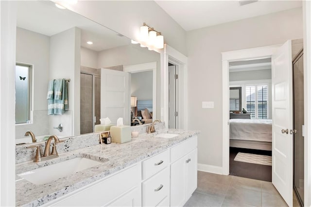 bathroom featuring a shower with door, vanity, and tile patterned floors