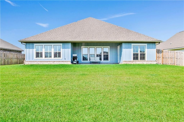 rear view of house with a lawn