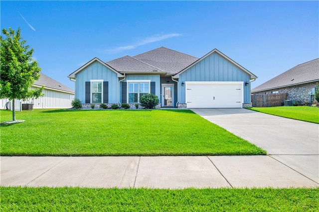 single story home featuring a garage and a front yard