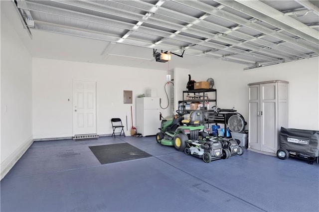 garage with a garage door opener, electric panel, and white refrigerator