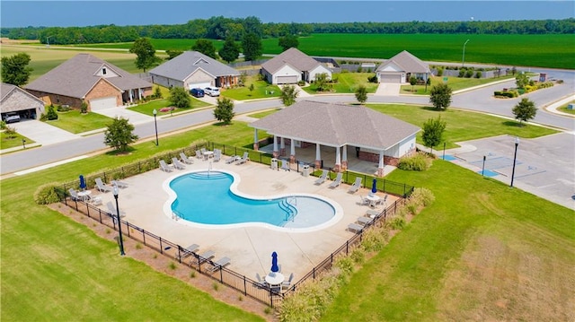 view of pool featuring a patio area and a yard