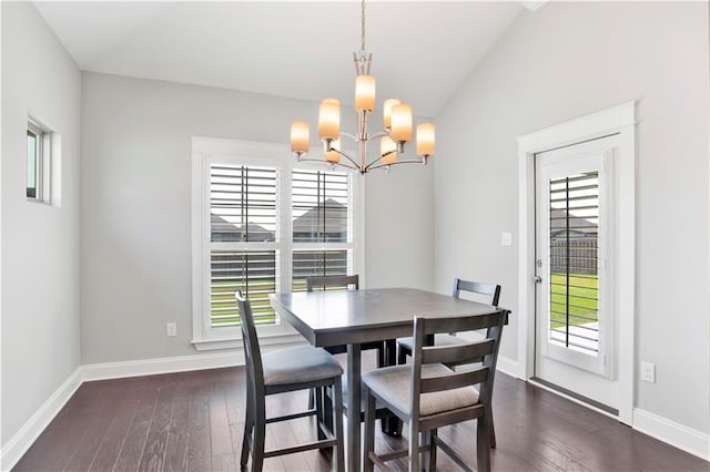 dining area with a notable chandelier, plenty of natural light, and dark hardwood / wood-style flooring