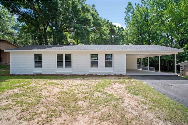 1452 Morlee Dr E, Mobile, AL 36618 - view of front facade featuring asphalt driveway, brick siding, and an attached carport