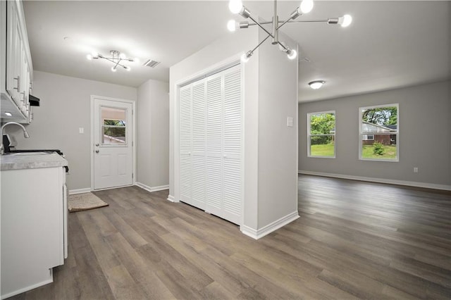 1452 Morlee Dr E, Mobile, AL 36618 - kitchen featuring a sink, healthy amount of natural light, white cabinetry, and dark wood finished floors