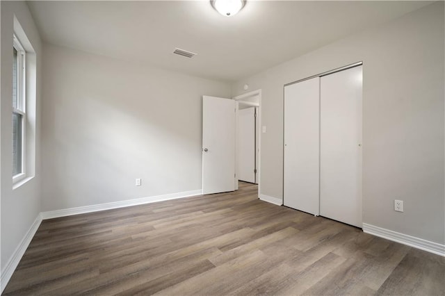 1452 Morlee Dr E, Mobile, AL 36618 - unfurnished bedroom featuring wood finished floors, a closet, and baseboards