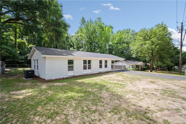 1452 Morlee Dr E, Mobile, AL 36618 - single story home featuring brick siding, driveway, cooling unit, and view of scattered trees