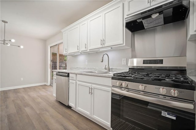 1452 Morlee Dr E, Mobile, AL 36618 - kitchen with stainless steel appliances, a sink, range hood, light wood-type flooring, and white cabinetry