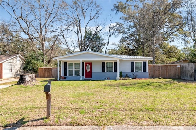 view of front facade with metal roof, a front lawn, a porch, and fence