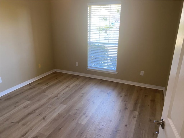 empty room with light hardwood / wood-style floors