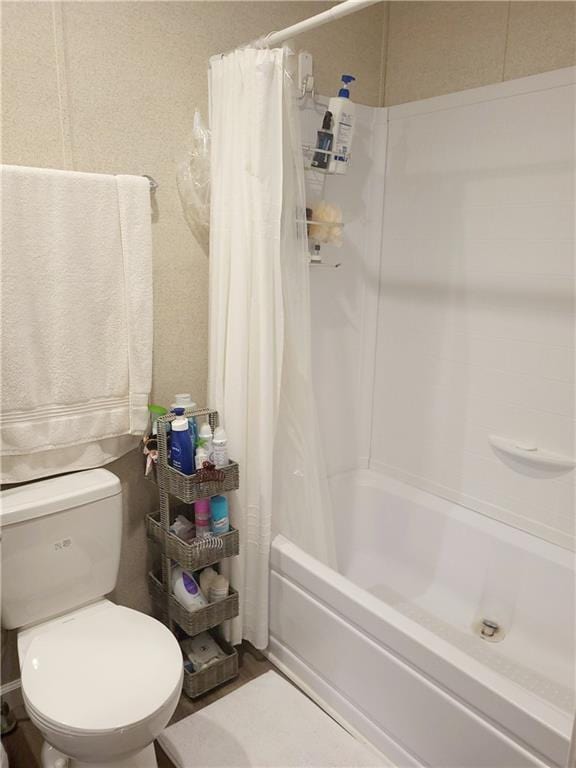 bathroom with toilet and shower / bath combo