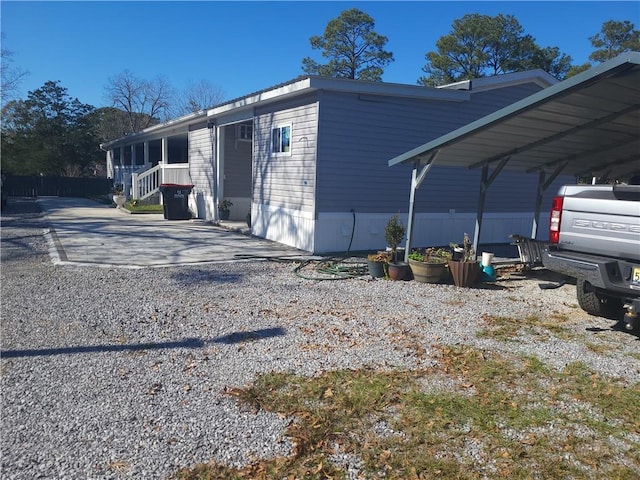 view of side of home featuring a carport