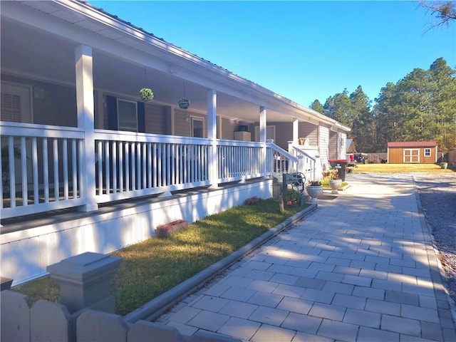 view of home's exterior with a storage shed and a yard