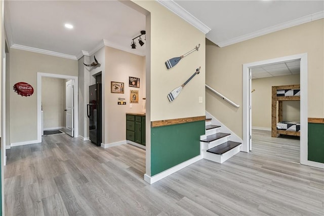 kitchen featuring black fridge, wood-type flooring, and track lighting