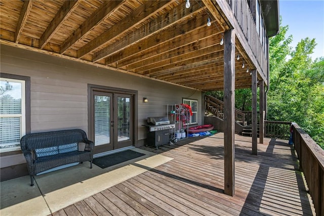 wooden deck with french doors and area for grilling