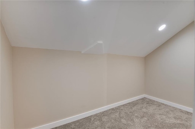 bonus room with carpet and vaulted ceiling