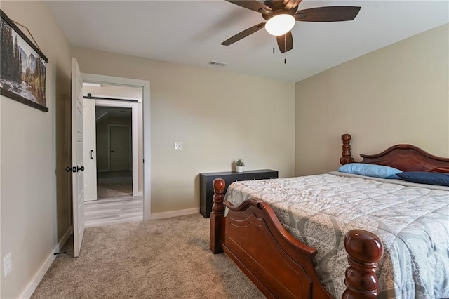 bedroom featuring light colored carpet and ceiling fan