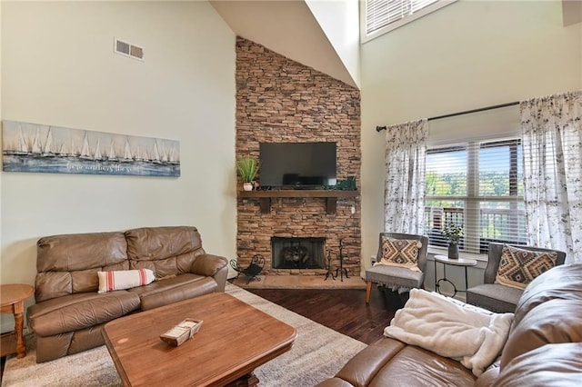 living room with dark wood-type flooring, a fireplace, and high vaulted ceiling