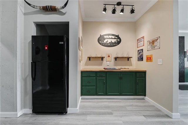 bathroom with crown molding, hardwood / wood-style flooring, and track lighting