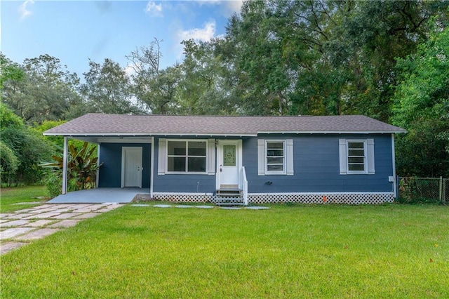 ranch-style home with a carport and a front yard