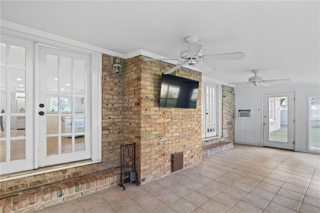 unfurnished living room featuring light tile patterned floors and crown molding