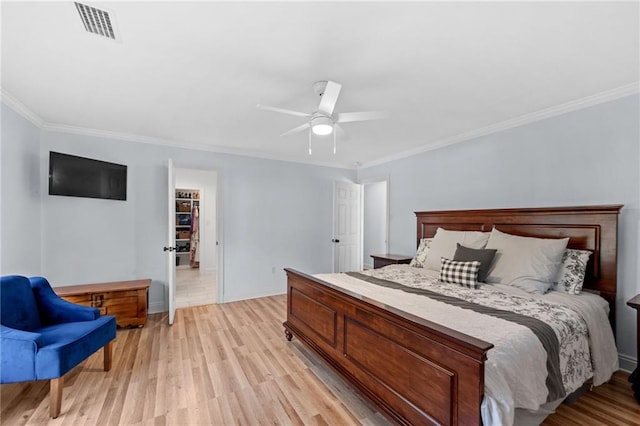 bedroom with light hardwood / wood-style flooring, ceiling fan, and ornamental molding