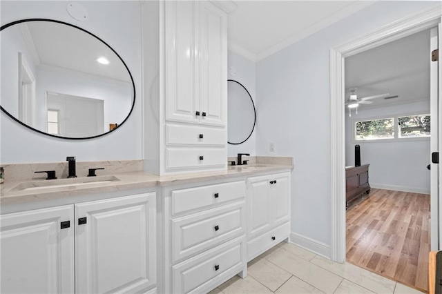 bathroom featuring ceiling fan, wood-type flooring, crown molding, and vanity