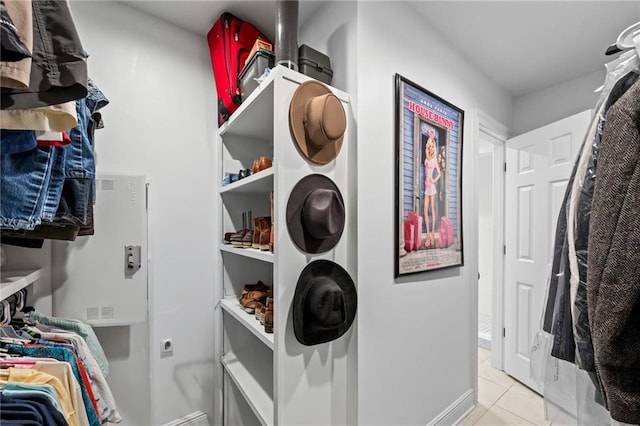 spacious closet with light tile patterned floors