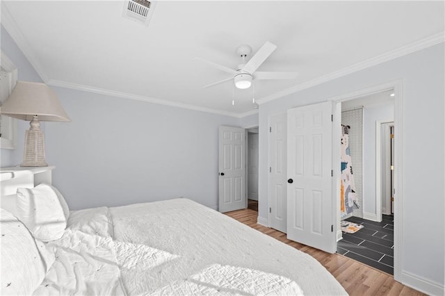 bedroom with hardwood / wood-style floors, ceiling fan, and crown molding