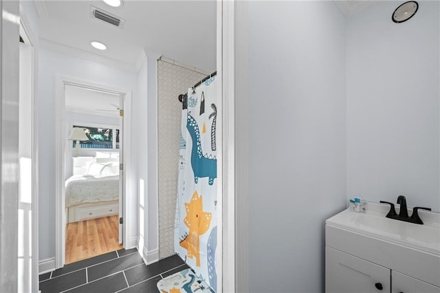 bathroom with curtained shower, crown molding, tile patterned flooring, and vanity