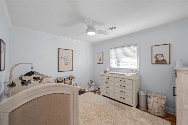 bedroom featuring ceiling fan, light wood-type flooring, and crown molding