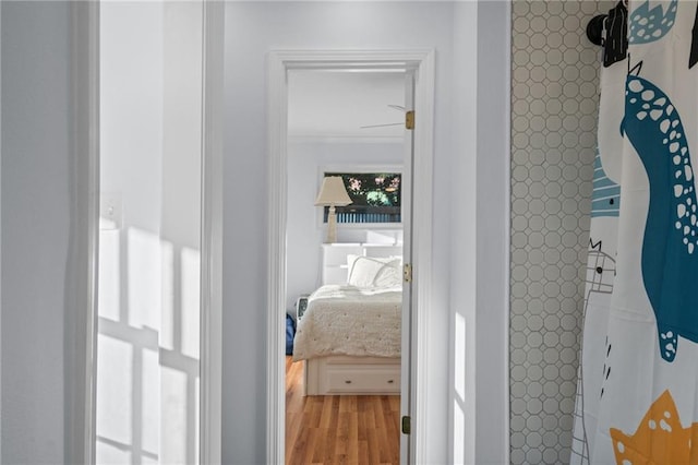 hallway featuring crown molding and wood-type flooring