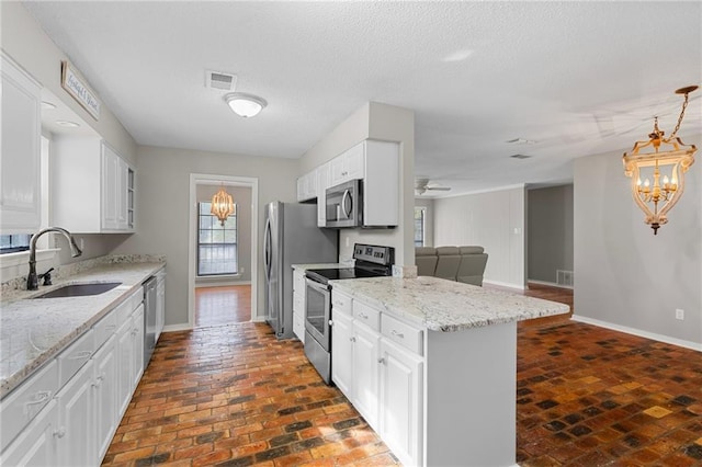 kitchen with white cabinetry, sink, stainless steel appliances, and light stone counters