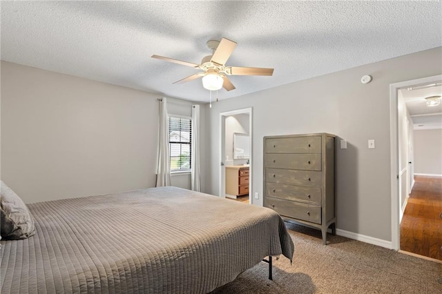 bedroom featuring carpet flooring, connected bathroom, ceiling fan, and a textured ceiling