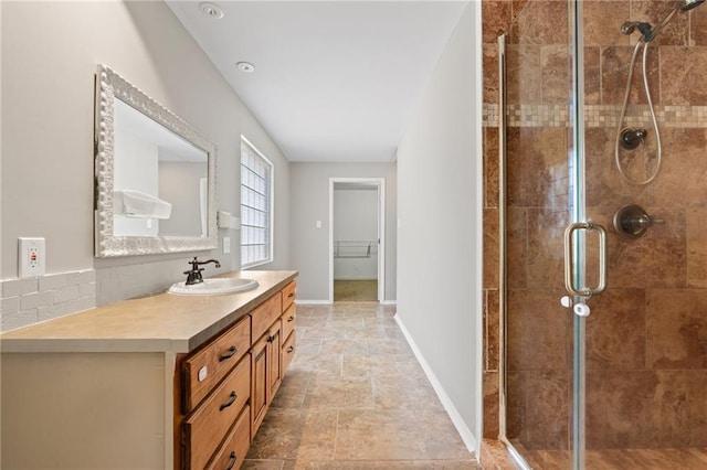 bathroom featuring vanity and an enclosed shower