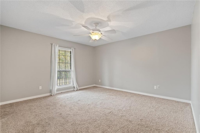 empty room with carpet flooring, a textured ceiling, and ceiling fan