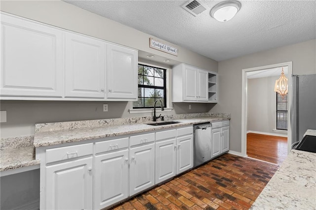 kitchen featuring white cabinetry, sink, stainless steel appliances, and a textured ceiling