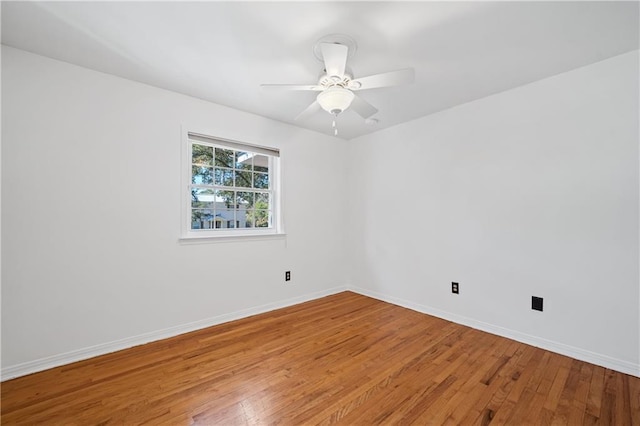 unfurnished room featuring baseboards, ceiling fan, and light wood-style floors