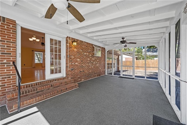 unfurnished sunroom with ceiling fan and beam ceiling