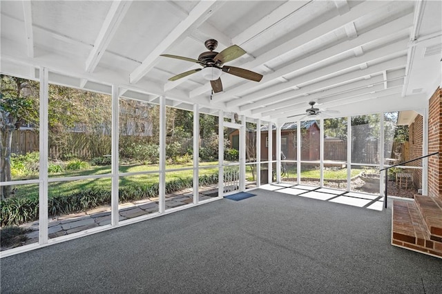 unfurnished sunroom featuring ceiling fan